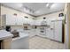 Bright kitchen featuring white cabinetry, tiled floors, and modern appliances at 3111 Sun Lake Ct # B, Kissimmee, FL 34747