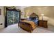 Warm bedroom with balcony access, featuring a classic wood bed frame and soft carpet at 3111 Sun Lake Ct # B, Kissimmee, FL 34747