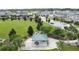An aerial view of a large green park with a picnic pavilion and playground in a residential neighborhood at 3193 Crispin Cir, Harmony, FL 34773