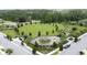 Aerial view of a well-maintained community park, featuring a playground and green spaces at 3193 Crispin Cir, Harmony, FL 34773