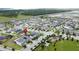 An aerial view of a neighborhood featuring single-Gathering homes, green spaces, and a playground at 3193 Crispin Cir, Harmony, FL 34773