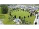Aerial view of a large green park with a picnic pavilion and playground in a residential neighborhood at 3193 Crispin Cir, Harmony, FL 34773