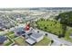 Aerial view of a neighborhood with a park, lake, and homes, pinpointing a home with solar panels at 3193 Crispin Cir, Harmony, FL 34773