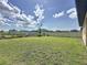 Large, green backyard with a white fence offers privacy and space for outdoor activities at 3193 Crispin Cir, Harmony, FL 34773