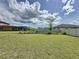 Large, green backyard with a white fence offers privacy and space for outdoor activities at 3193 Crispin Cir, Harmony, FL 34773