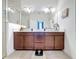 Bathroom featuring a double vanity, shower, and neutral decor at 3193 Crispin Cir, Harmony, FL 34773
