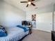 Bedroom featuring a large window, desk setup, and neutral carpeting at 3193 Crispin Cir, Harmony, FL 34773