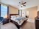 Spacious bedroom with ceiling fan, carpeting, and connecting bathroom at 3193 Crispin Cir, Harmony, FL 34773