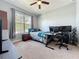 Bedroom featuring a large window, desk setup, and neutral carpeting at 3193 Crispin Cir, Harmony, FL 34773