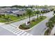 View of the community entrance sign amidst palm trees and landscaping in a residential neighborhood at 3193 Crispin Cir, Harmony, FL 34773
