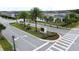 View of the community entrance sign amidst palm trees and landscaping in a residential neighborhood at 3193 Crispin Cir, Harmony, FL 34773