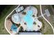 Aerial view of an aquatic community pool with lounge chairs, playground and splash pad at 3193 Crispin Cir, Harmony, FL 34773