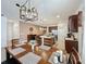 Open-concept dining room showcases a wooden table with seating for six, flowing into a kitchen with an island at 3193 Crispin Cir, Harmony, FL 34773
