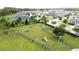 An aerial view of a fenced dog park featuring agility equipment and benches in a residential neighborhood at 3193 Crispin Cir, Harmony, FL 34773