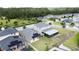 View of rear yard with solar panels and screened lanai of bright two-story home in residential neighborhood at 3193 Crispin Cir, Harmony, FL 34773