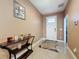 Inviting foyer featuring neutral tones, tiled flooring, and decorative console table with decor at 3193 Crispin Cir, Harmony, FL 34773