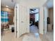 Hallway view showing access to a full bathroom and a bedroom/office space with an open door at 3193 Crispin Cir, Harmony, FL 34773
