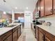 Bright kitchen features stainless steel appliances, ample counter space, and rich wood cabinetry at 3193 Crispin Cir, Harmony, FL 34773