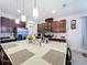 Bright kitchen island with quartz countertops, stainless appliances, and rich wood cabinetry at 3193 Crispin Cir, Harmony, FL 34773