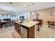 Spacious kitchen island with a sink and dishwasher overlooks the dining and living areas at 3193 Crispin Cir, Harmony, FL 34773