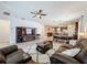 Spacious living room with a ceiling fan, large TV, and modern furnishings and decor at 3193 Crispin Cir, Harmony, FL 34773
