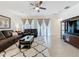 Cozy living room featuring a comfortable sofa and plentiful natural lighting with stylish decor at 3193 Crispin Cir, Harmony, FL 34773