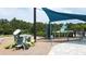 Community playground with climbing structure, slide and sunshade at 3193 Crispin Cir, Harmony, FL 34773