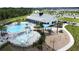 A splashpad and playground near the community pool with picnic tables and sunshades at 3193 Crispin Cir, Harmony, FL 34773