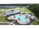 A large community pool with a clubhouse, splashpad and playground is surrounded by lush landscaping at 3193 Crispin Cir, Harmony, FL 34773