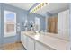 Bright bathroom with double sinks, tile floor, and a large mirror for an open feel at 3214 Herons Point Cir, Kissimmee, FL 34741