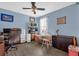 This bedroom features dark wood laminate floors, a ceiling fan, and calming blue walls at 3214 Herons Point Cir, Kissimmee, FL 34741