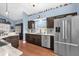 Updated kitchen with stainless steel appliances, dark cabinets, and tile backsplash has room to cook at 3214 Herons Point Cir, Kissimmee, FL 34741