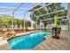 Inviting screened pool area with waterfall feature and ample seating for guests at 3214 Herons Point Cir, Kissimmee, FL 34741