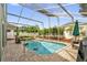 Beautiful pool area with a screened enclosure surrounded by lush landscaping at 3214 Herons Point Cir, Kissimmee, FL 34741