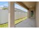 Covered back porch area with concrete flooring, exterior lighting, and a view of the fenced-in yard at 328 Lily Ln, Davenport, FL 33837