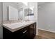 Neutral bathroom with granite counters and dark brown cabinets at 328 Lily Ln, Davenport, FL 33837