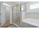 Bathroom featuring a glass shower and tub with tiled walls at 328 Lily Ln, Davenport, FL 33837