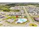 Scenic aerial view highlights the community's pool, clubhouse, and proximity to a serene lake at 328 Lily Ln, Davenport, FL 33837