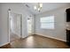 Bright dining room with wood floors, modern lighting, and neutral paint at 328 Lily Ln, Davenport, FL 33837