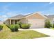 Beautiful single-story home with a well-maintained lawn and attached two-car garage at 328 Lily Ln, Davenport, FL 33837