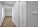 Bright hallway with wood-look flooring and a white door to the side at 328 Lily Ln, Davenport, FL 33837