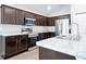 Modern kitchen with stainless steel appliances and dark wood cabinetry at 328 Lily Ln, Davenport, FL 33837