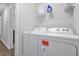 Laundry room features a washing machine, dryer, and ample storage on the rack above at 328 Lily Ln, Davenport, FL 33837