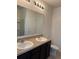 Well-lit bathroom showcasing double sinks, granite countertop and a large vanity mirror at 359 Arbor Lakes Dr, Davenport, FL 33896