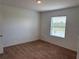 Bright bedroom with carpeted floors and large window offering serene pond views at 359 Arbor Lakes Dr, Davenport, FL 33896