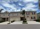 Inviting two-story townhome with a one-car garage, neutral siding, and manicured landscaping at 359 Arbor Lakes Dr, Davenport, FL 33896