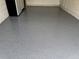 Spacious garage with epoxy flooring and ample space for parking and storage at 359 Arbor Lakes Dr, Davenport, FL 33896