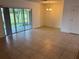 Bright living space with tile floors, a sliding glass door to a screened-in patio, and modern lighting at 359 Arbor Lakes Dr, Davenport, FL 33896