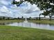 Picturesque pond view featuring a fountain, lush landscaping, and well-maintained community grounds at 359 Arbor Lakes Dr, Davenport, FL 33896