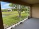 Relaxing screened porch with beautiful views of the pond, trees, and surrounding community at 359 Arbor Lakes Dr, Davenport, FL 33896